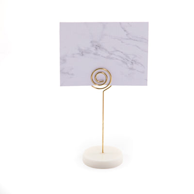 Hexagonal marble card stand with a golden steel column